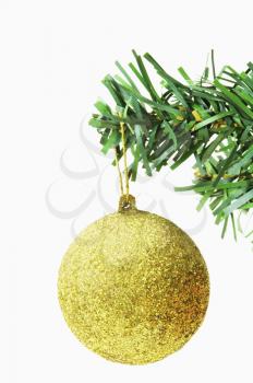 Golden bauble hanging on a Christmas tree