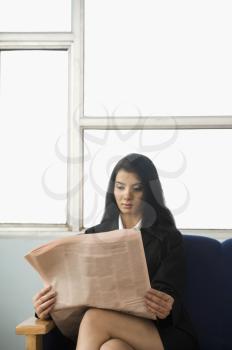 Businesswoman reading a financial newspaper