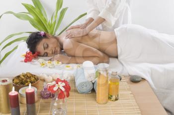 Young woman getting back massage from a massage therapist