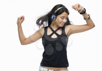 Young woman listening to music and dancing