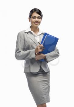 Portrait of a businesswoman holding a file and standing against a white background