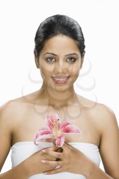 Portrait of a young woman holding a flower