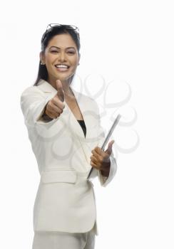 Portrait of a businesswoman showing thumbs up