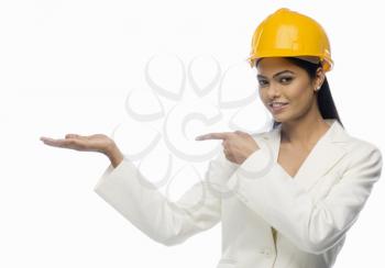 Portrait of a female architect pointing towards her palm