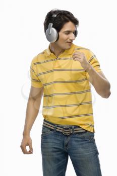 Young man listening musing and dancing