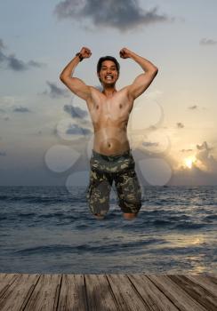 Portrait of a young man jumping with joy