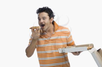 Close-up of a man eating pizza