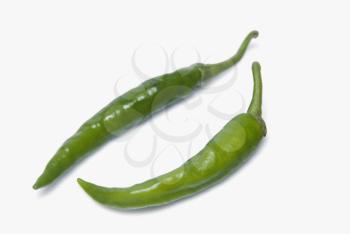 Close-up of two green chili peppers