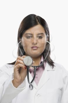 Female doctor examining with a stethoscope
