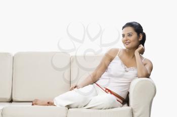 Woman sitting on a couch and smiling