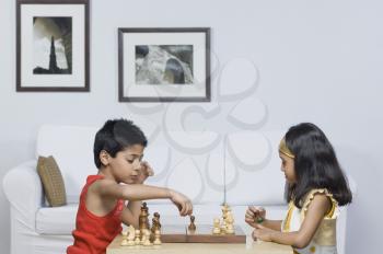 Boy and a girl playing chess