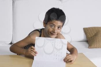 Portrait of a boy showing his notes