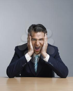 Close-up of a businessman screaming
