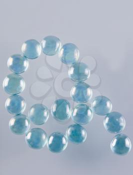 Close-up of marble balls arranged in the shape of letter Q