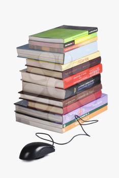 Close-up of a stack of books and a computer mouse