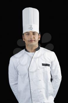 Portrait of a chef standing with hands behind back