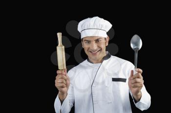Chef holding a rolling pin and a ladle