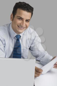 Businessman holding a document and smiling