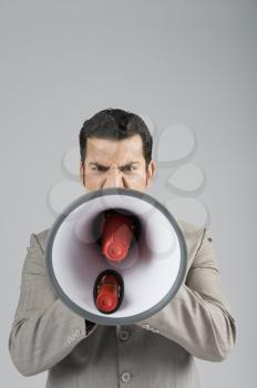 Businessman shouting into a megaphone