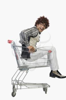 Portrait of a man sitting in a shopping cart