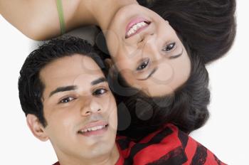 High angle view of a couple lying on the floor and smiling