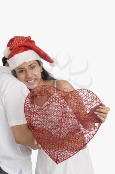 Couple wearing Santa hats and romancing
