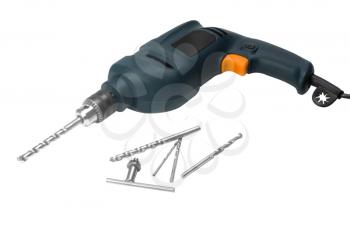Close-up of an electric drill with drill bits and a key