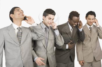 Four businessmen talking on mobile phones