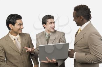 Three businessmen with a laptop