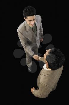 High angle view of two businessmen shaking hands