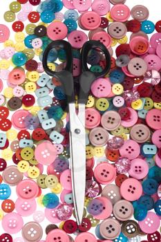 Scissors on a heap of buttons