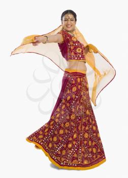 Woman dancing in bright red lehenga choli