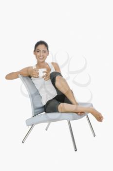 Woman sitting on a chair and drinking tea