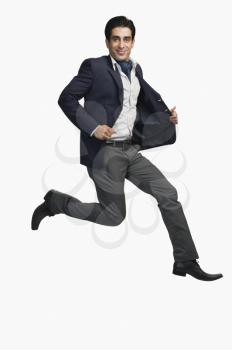 Portrait of a man jumping against a white background