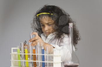 Girl dressed as scientist researching in the laboratory