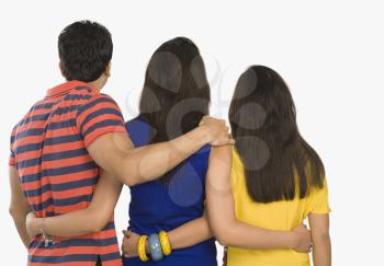 Rear view of three friends standing