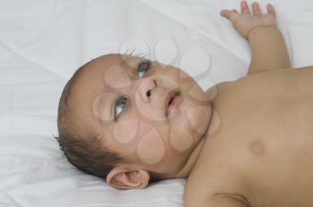 Close-up of a baby boy lying on the bed