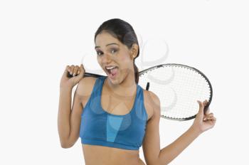 Woman holding a tennis racket and smiling