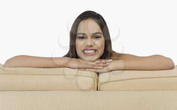 Portrait of a woman leaning on a couch