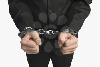 Close-up of a businessman tied up with handcuffs