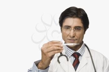 Doctor reading a thermometer