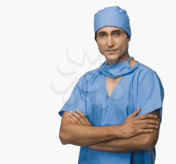 Portrait of a surgeon standing with arms crossed