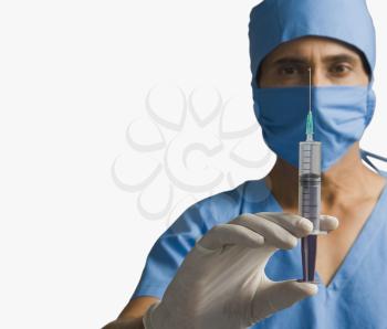 Surgeon holding a syringe