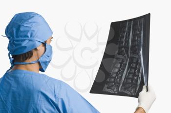 Surgeon examining an x-ray report