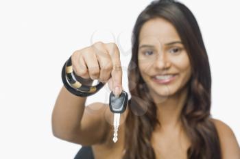 Portrait of a woman showing a car key