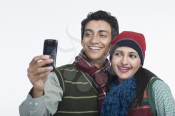 Couple taking a picture of themselves with a camera phone