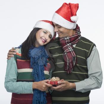 Man giving Christmas present to a woman