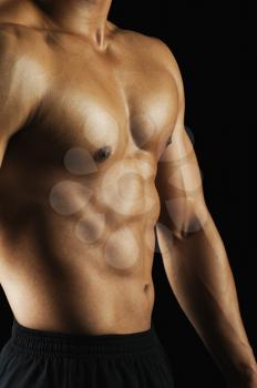 Mid section view of a muscular man showing his abs