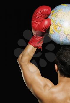 Male boxer holding a globe over his head
