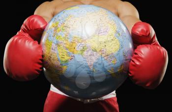 Mid section view of a boxer holding globe
